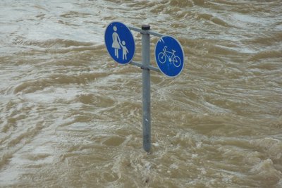 Rising flood water with road sign