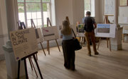 Two people look at an exhibition on 'a change in the climate.