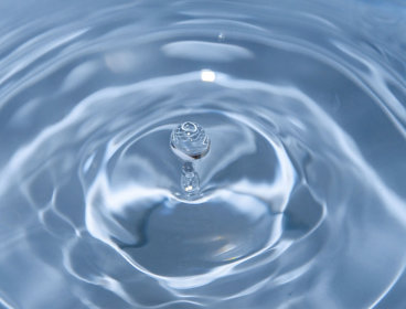 A water drop falling into water.