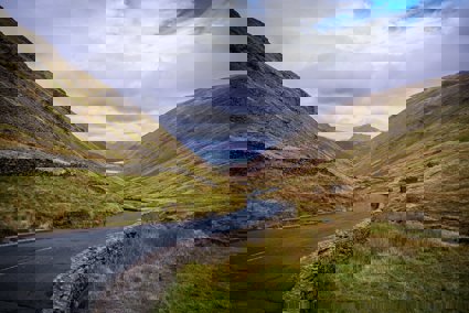 A widning road through a valley in the Lake District
