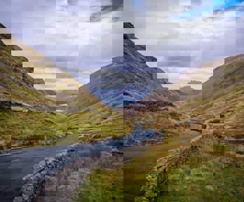 A widning road through a valley in the Lake District