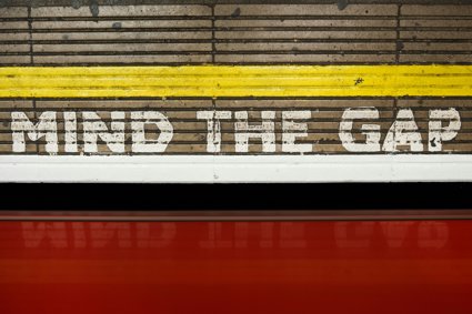 Mind the Gap sign painted onto a station platform floor