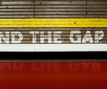 Mind the Gap sign painted onto a station platform floor