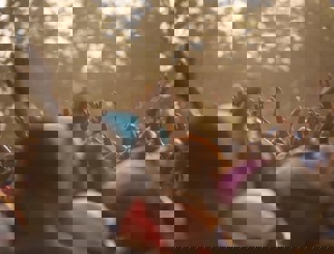 A crowd of people with their hands in the air