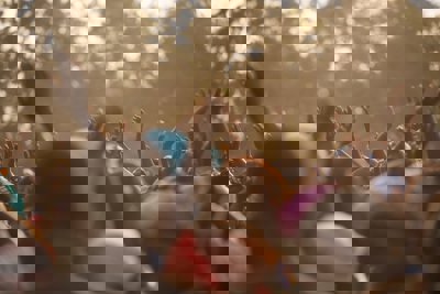 A crowd of people with their hands in the air
