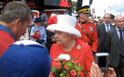 A man talking to the former queen of England. 