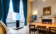 A grand council room with a plasma screen for presentations. 