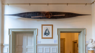 Kayak hangs on the wall in the Society