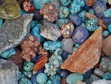 A selection of precious stones in blues, oranges and greys
