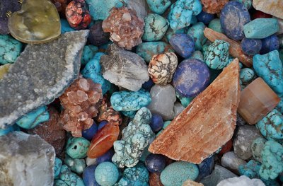 A selection of precious stones in blues, oranges and greys