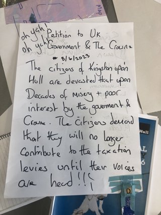 A petition from 2023 written on a white piece of paper with black handwriting