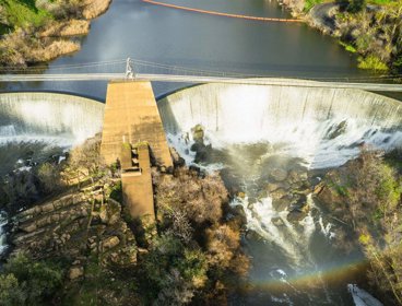 An aerial view of a bridge over a dammed river.