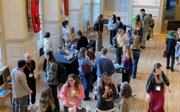 Conference delegates in a main hall seen from above.