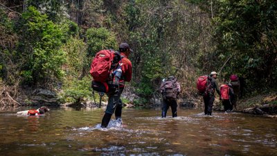 Group trekking in water.