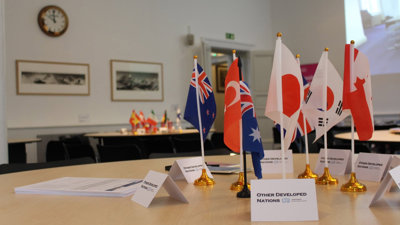 Table with flags representing different nations at a COP event.