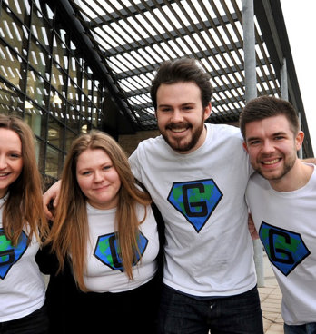 Group of people posing for a photo with their arms around each other's shoulders.