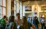Conference attendees networking in the Main Hall at the Royal Geographical Society.