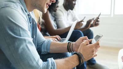 Group of people sitting on their mobile phones and laptops.