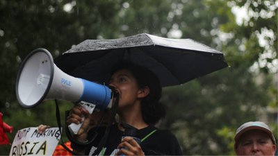 Person holding megaphone at protest.
