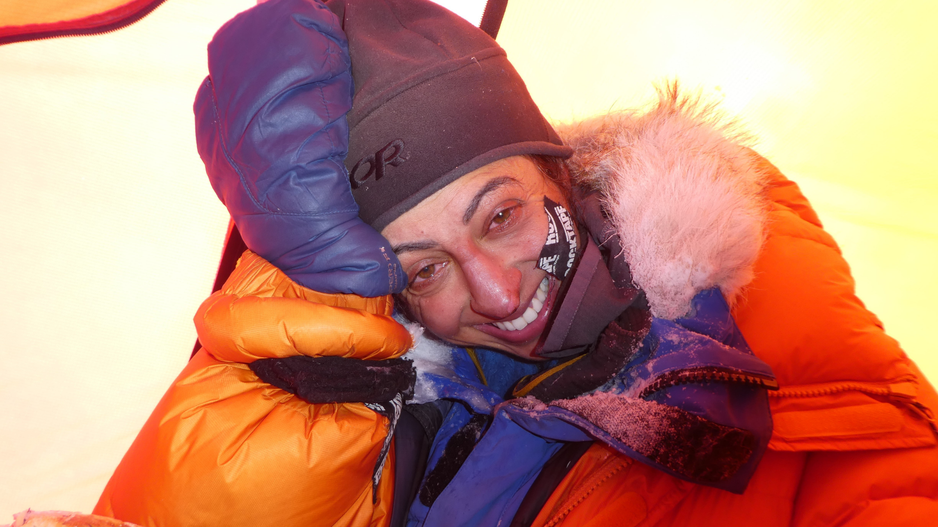 Preet Chandi in snow gear smiling through her tears.