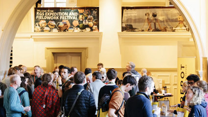 Explore symposium attendees gather in the Main Hall of the Royal Geographical Society to browse the exhibitors' stands.