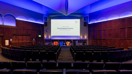The Ondaatje Theatre at the Society with a screen that says welcome to the Royal Geographical Society.