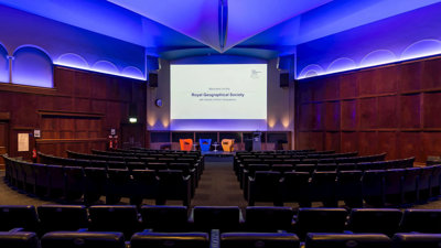 The Ondaatje Theatre at the Society with a screen that says welcome to the Royal Geographical Society.