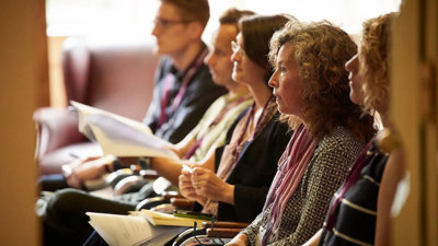 Conference delegates listening attentively to a presentation.