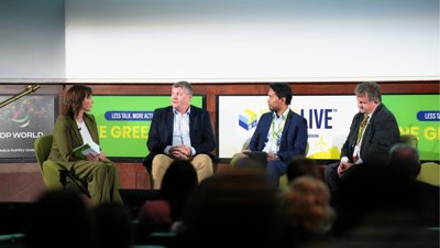 Four people sitting on panel on stage.