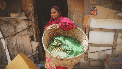 A woman holding prodcue in a basket