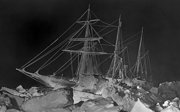 Old black and white photograph of Endurance stuck in ice at night.