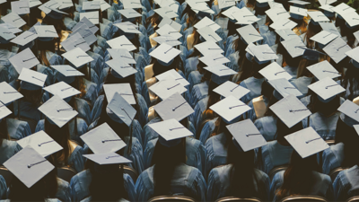 Rows of students at a graduation ceremony are captured from above
