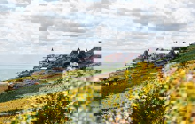A village on a hill overlooking a lake