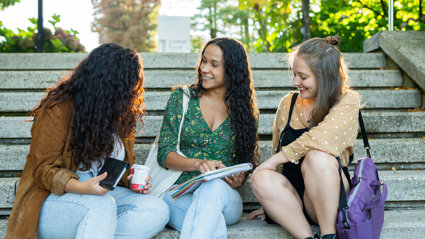 People sitting on stone steps whilst chatting