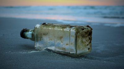Plastic bottle washed up on a sandy beach