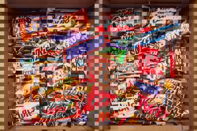Variety of different brands of chocolate bars in a box.