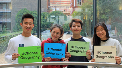 Four young people holding up signs with the text Choose Geography.