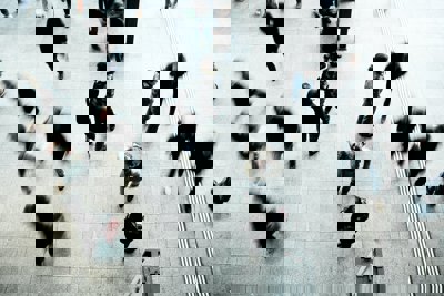 People walking on a grey concrete floor