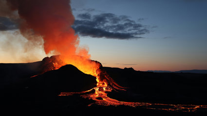 A volcano erupting lava.