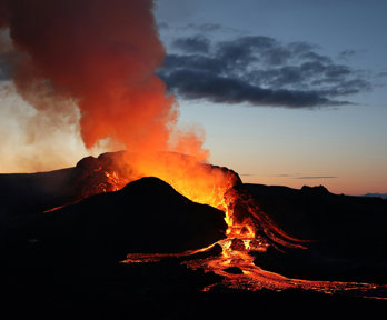 A volcano erupting lava.