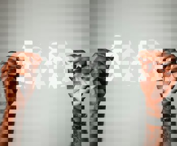 Hands holding paper people