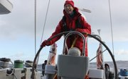 A man at the helm of a boat.