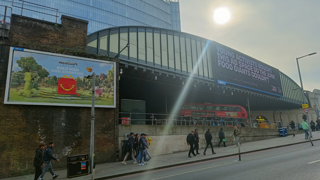 Advertising billboards in a city, one of a fast food chain, and one saying 'Young activists bought this ad space so the junk food giants couldn't'.