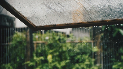 An open window exposing heavy rain outside