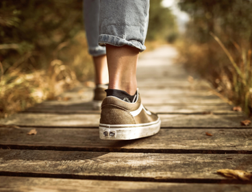 Close-up shot of shoes of someone walking. 