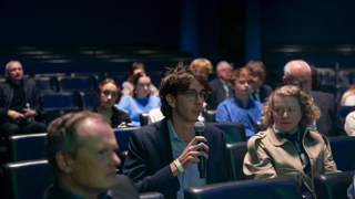 Audience member asking question in Ondaatje Theatre.