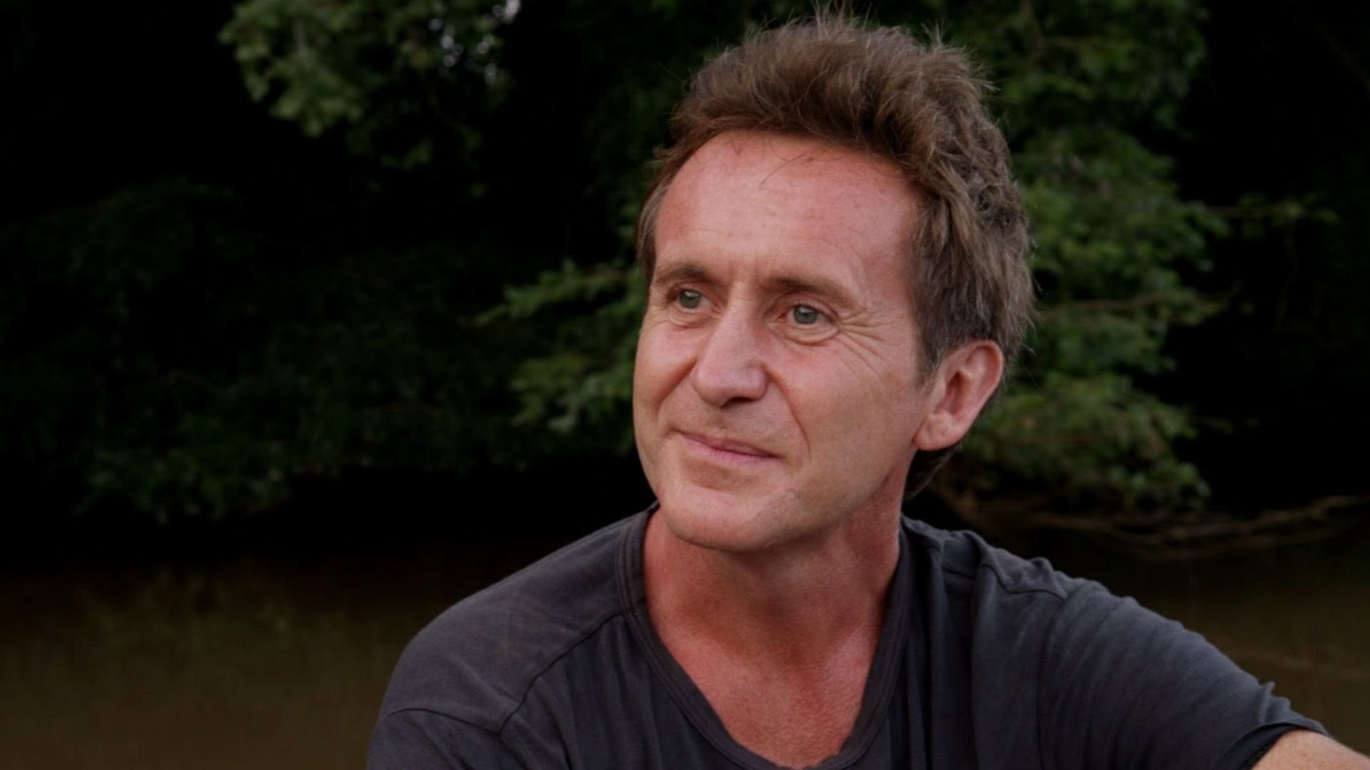 Headshot of Bruce Parry against tree background.