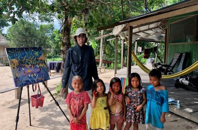 John Dyer pictured in the Amazon rainforest tribal village of Mutum in the Acre region of Brazil with children of the Yawanawá tribe