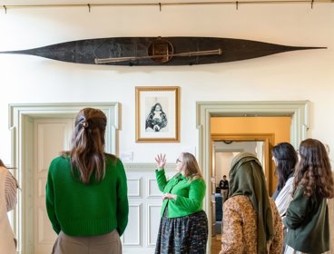 People listening to tour guide at Lowther Lodge.