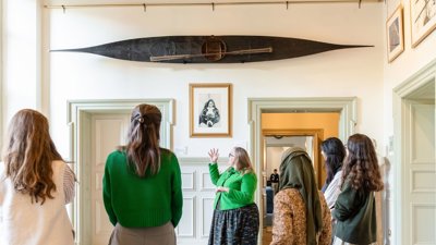 People listening to tour guide at Lowther Lodge.